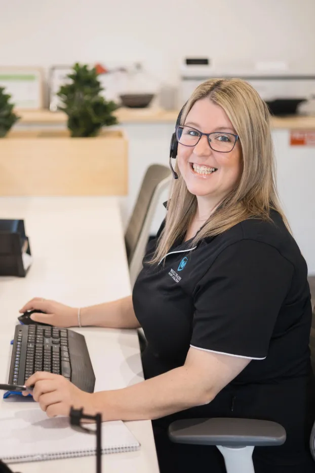 WestOz customer service team member smiling while assisting a client from the Wangara office